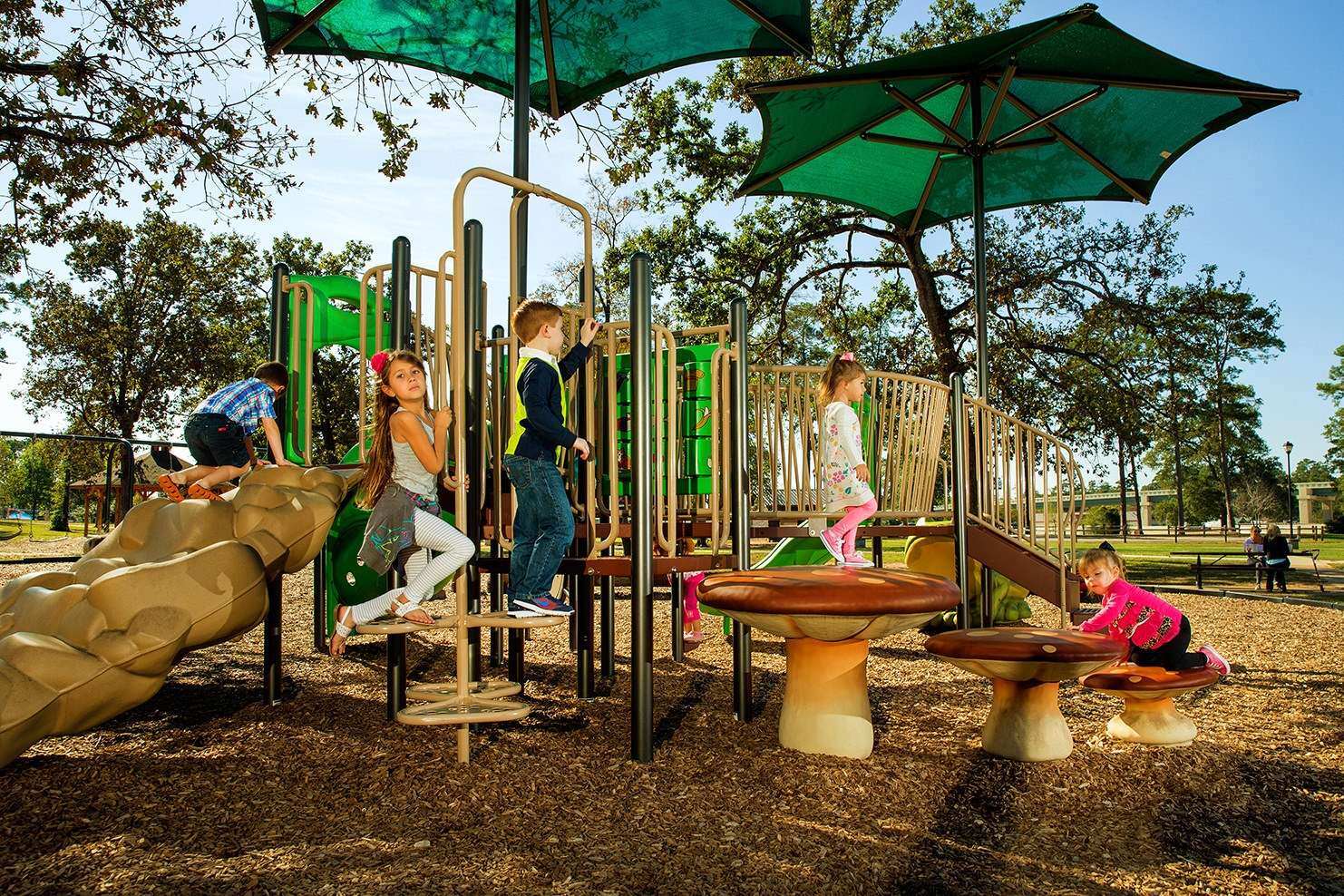 Image of a group of children walking across different playground equipment 