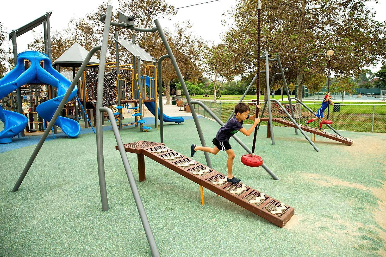 Image of a child running down the ramp of a zip line