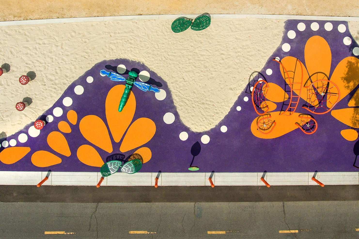 Image of a playground that portrays dragonflies and flowers