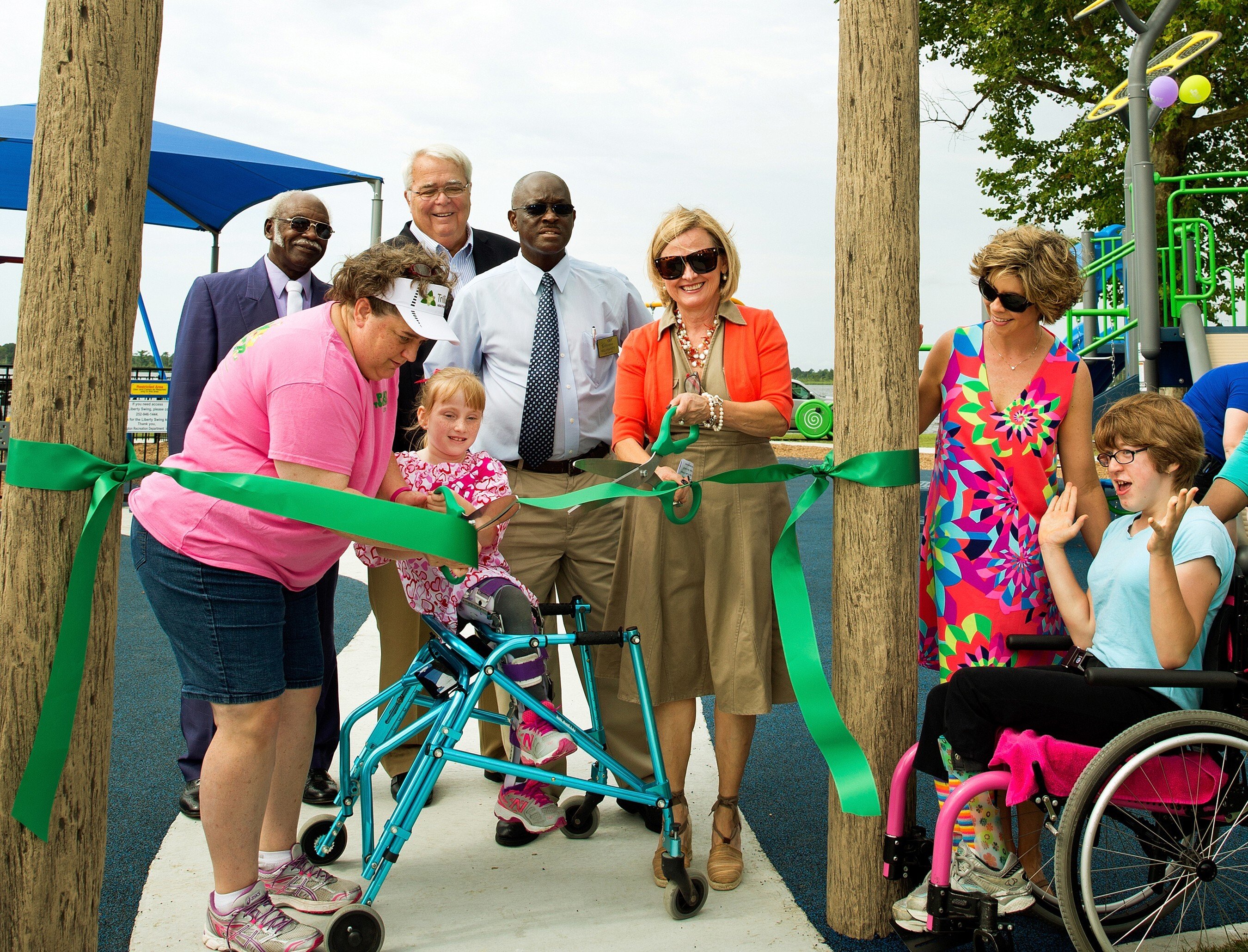 Group of people at the ribbon cutting for an inclusive playground