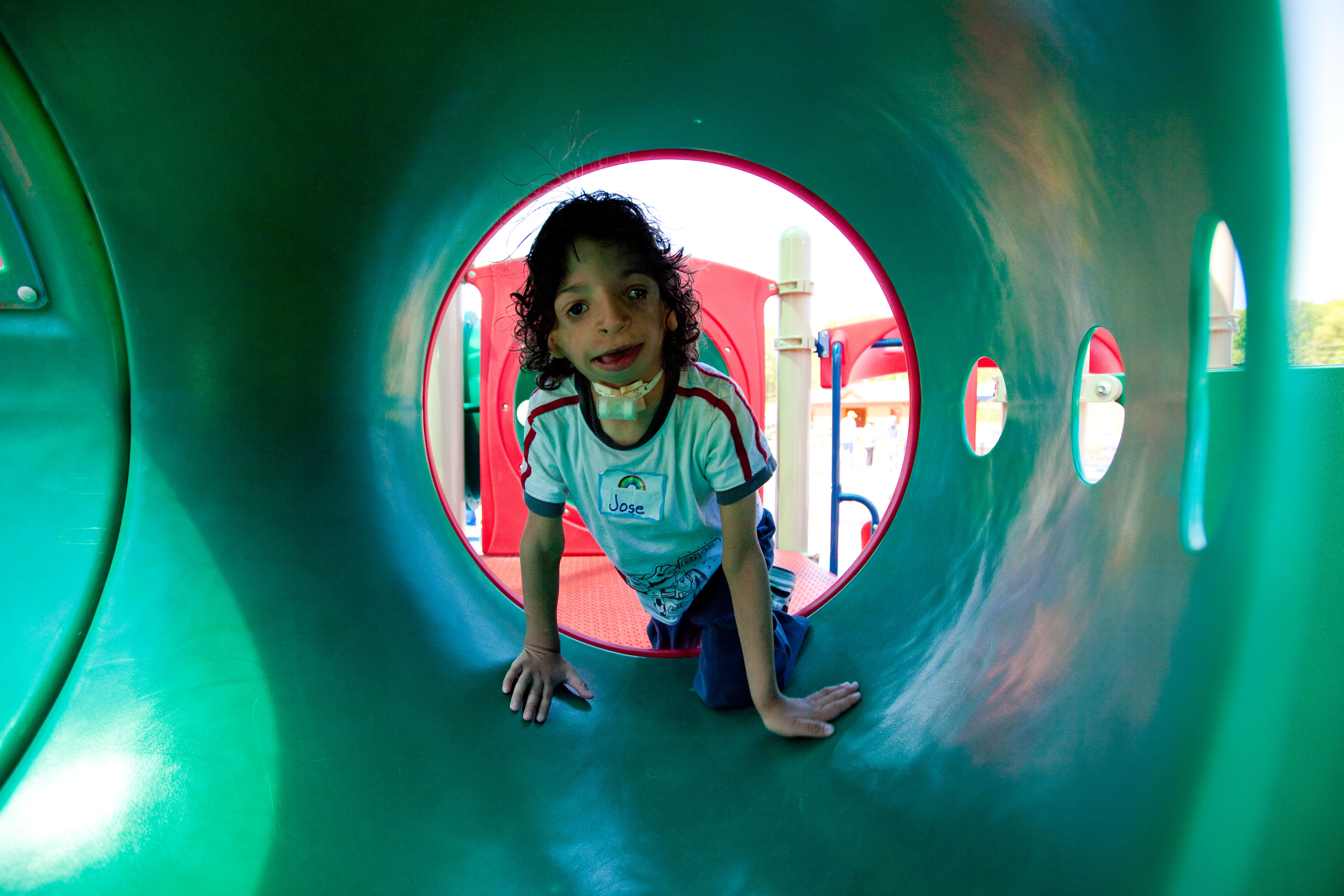 child playing in accessible cozy spot play structure