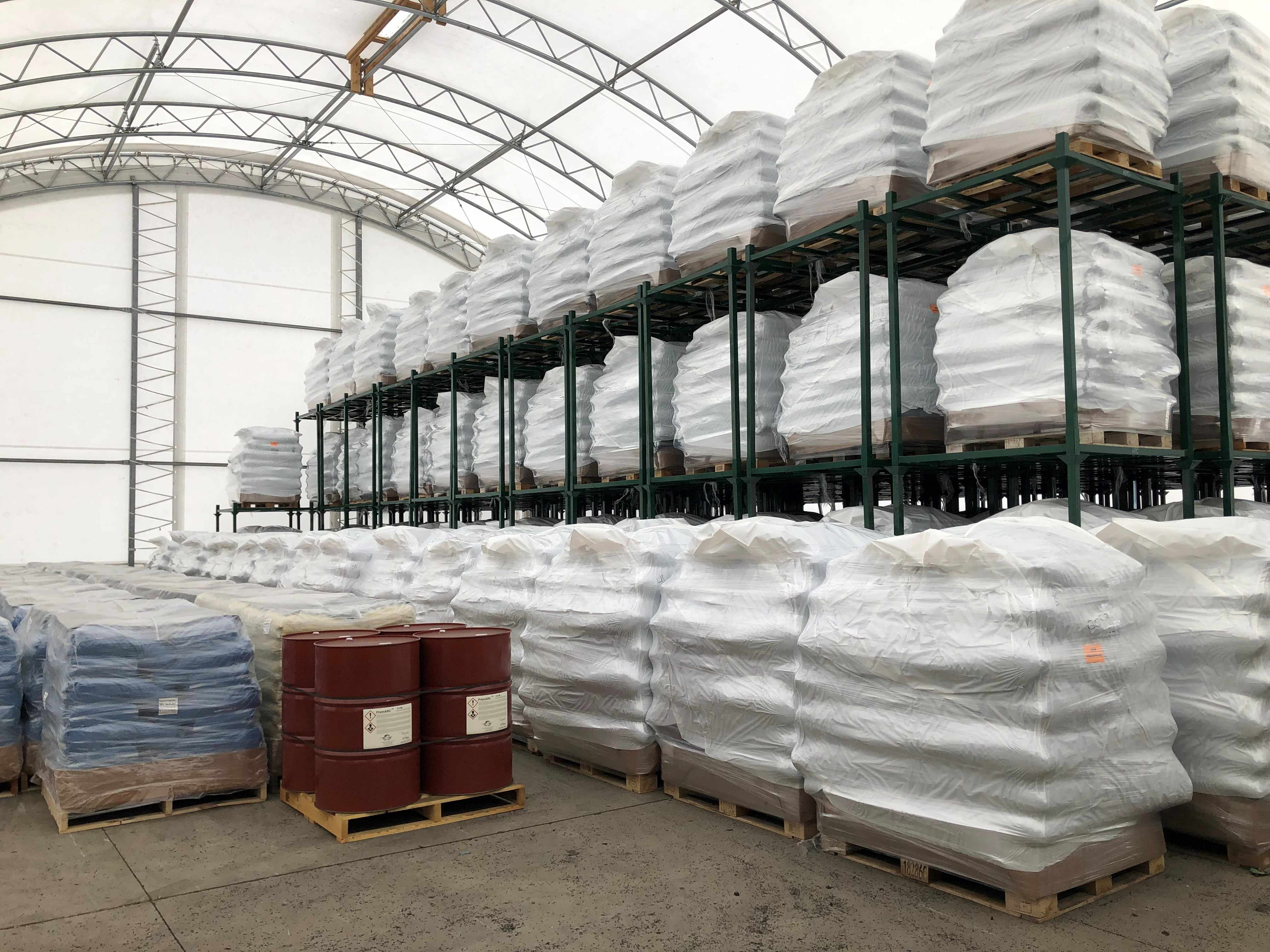 Warehouse facility image with pallets of rubber granuals.