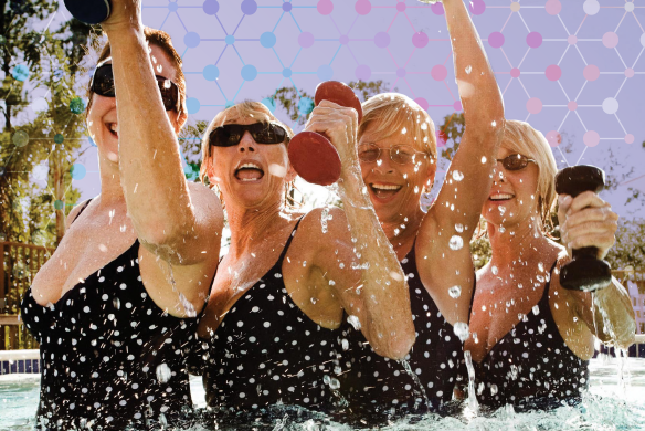 Four elderly women wearing polka dot swimsuits and smiling in unison as they do arm workouts in the pool