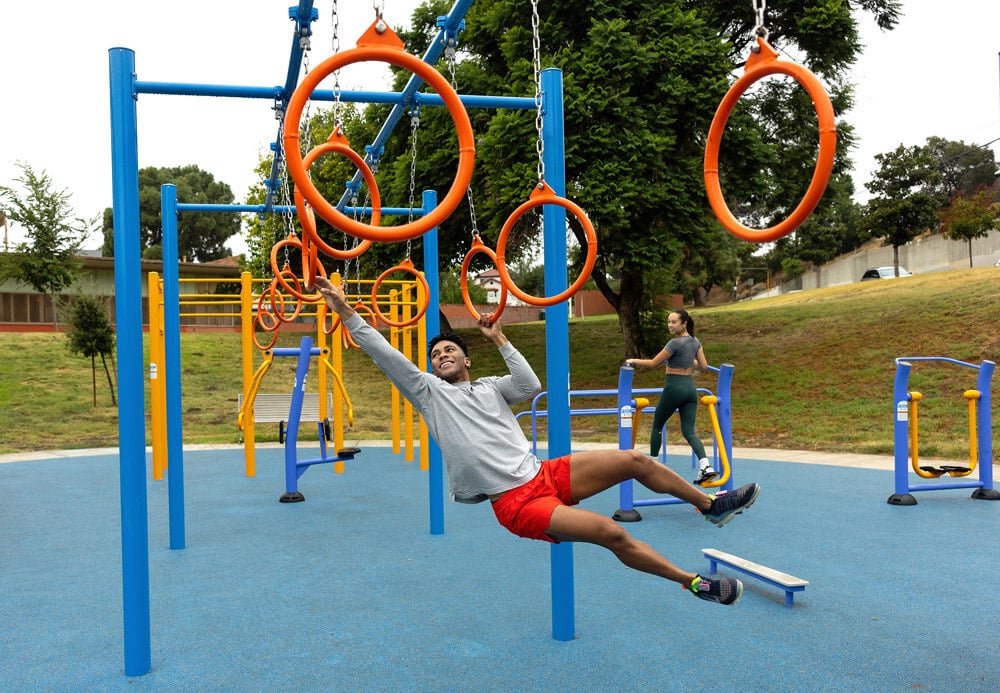 A black man reaching for an orange circle as he tries to get across