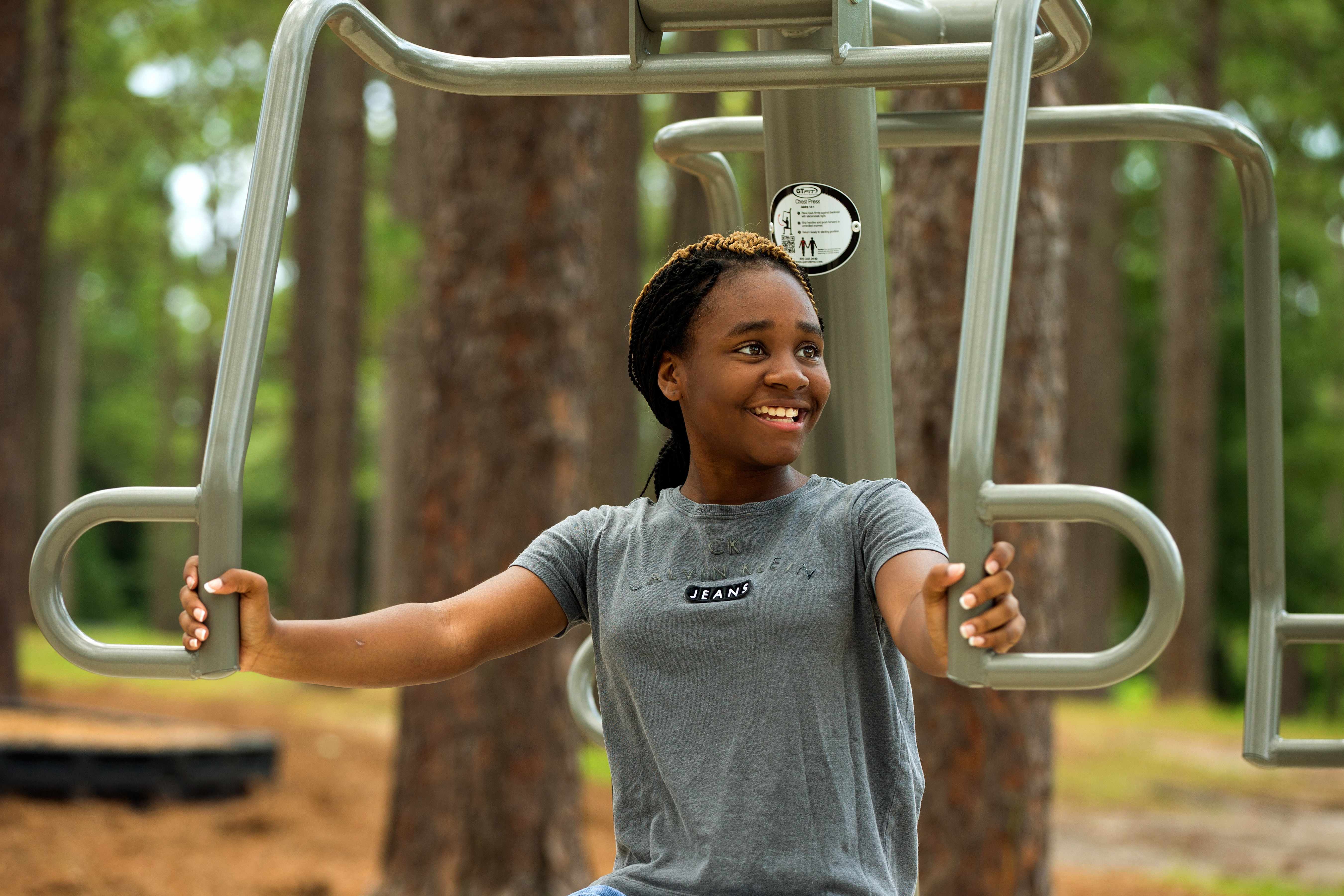 Image of a young women exercising in the outdoors. 