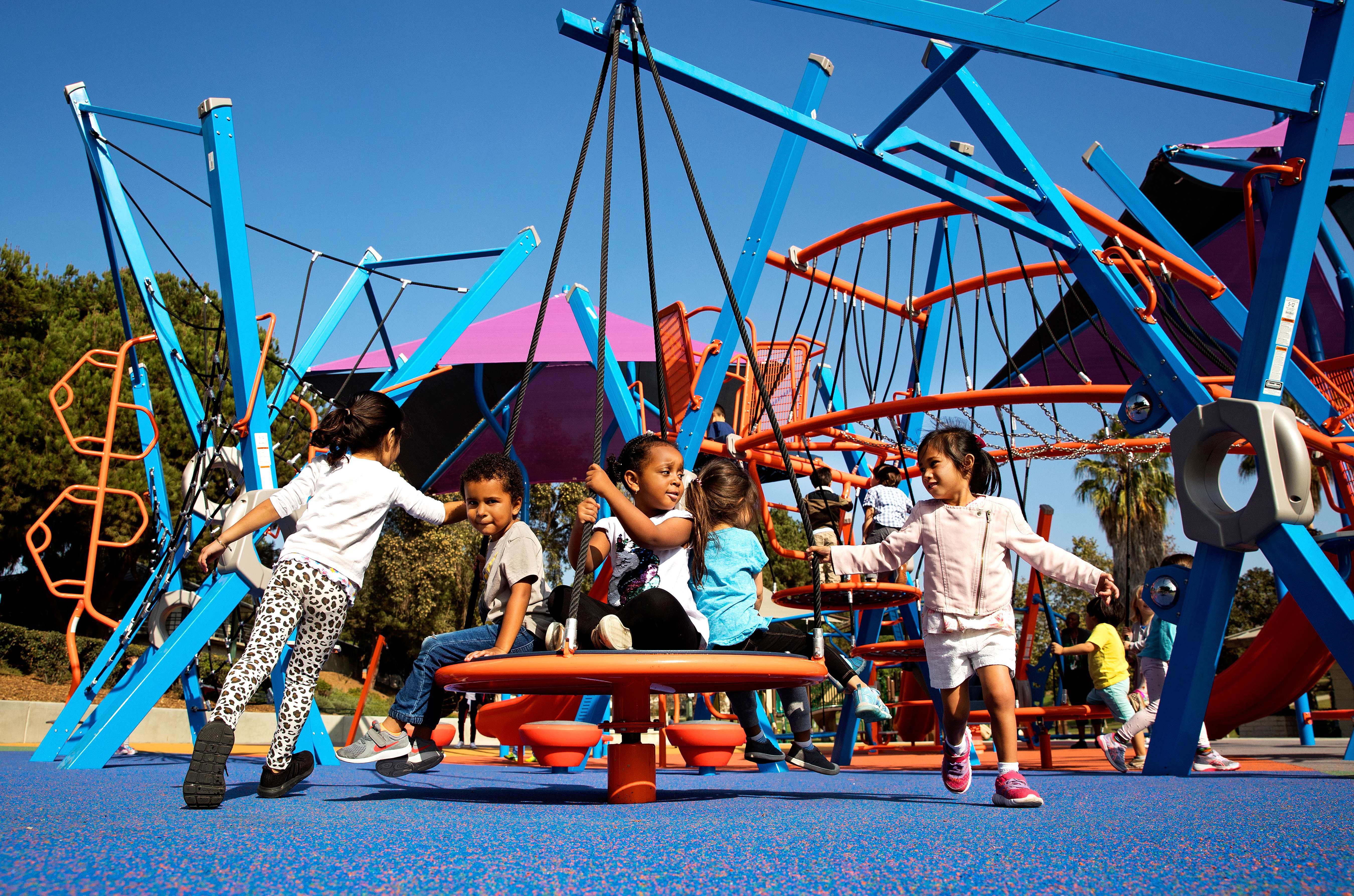 image of a group of children playing together on a playground set