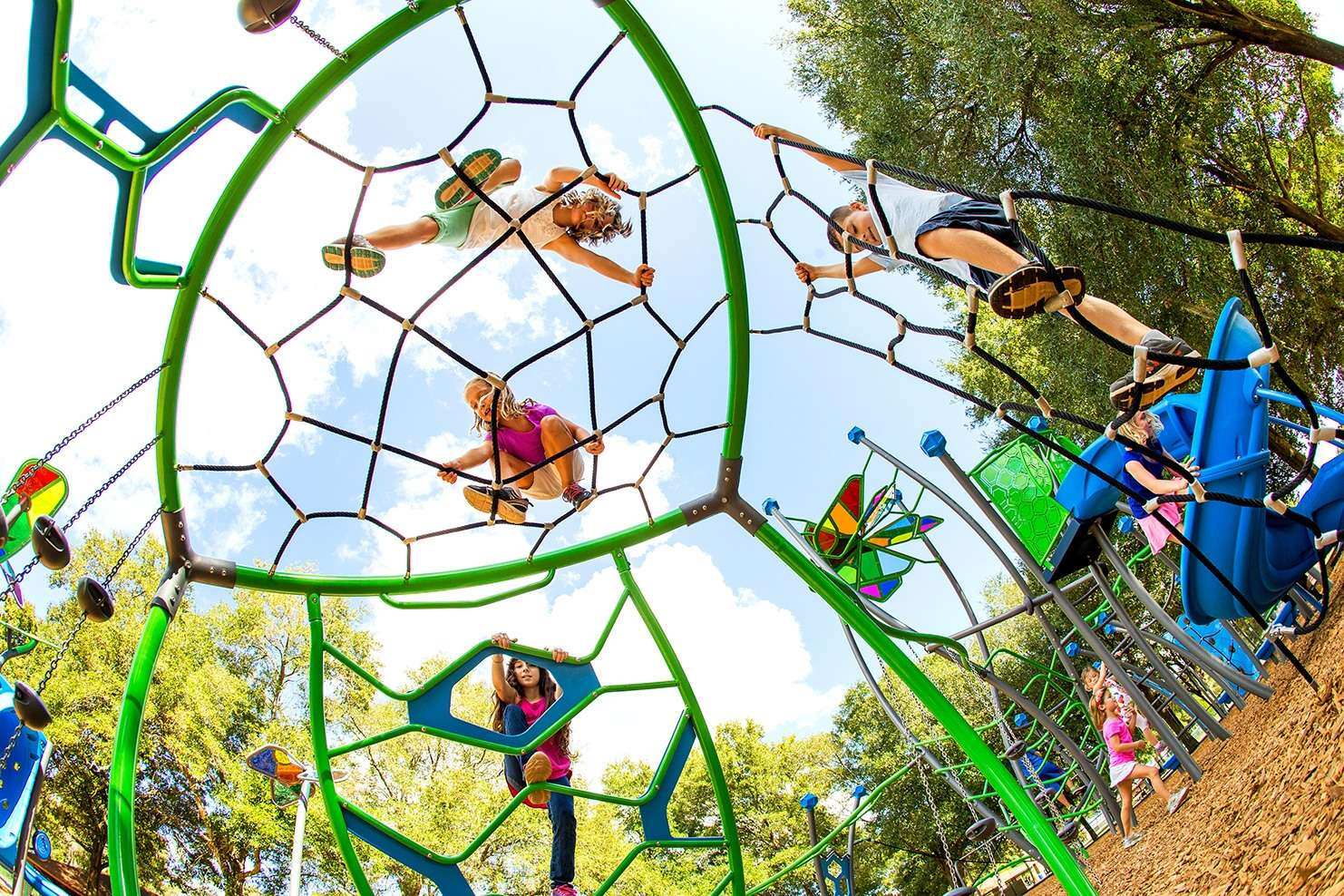 Image of a group of children playing atop of a climbing dome