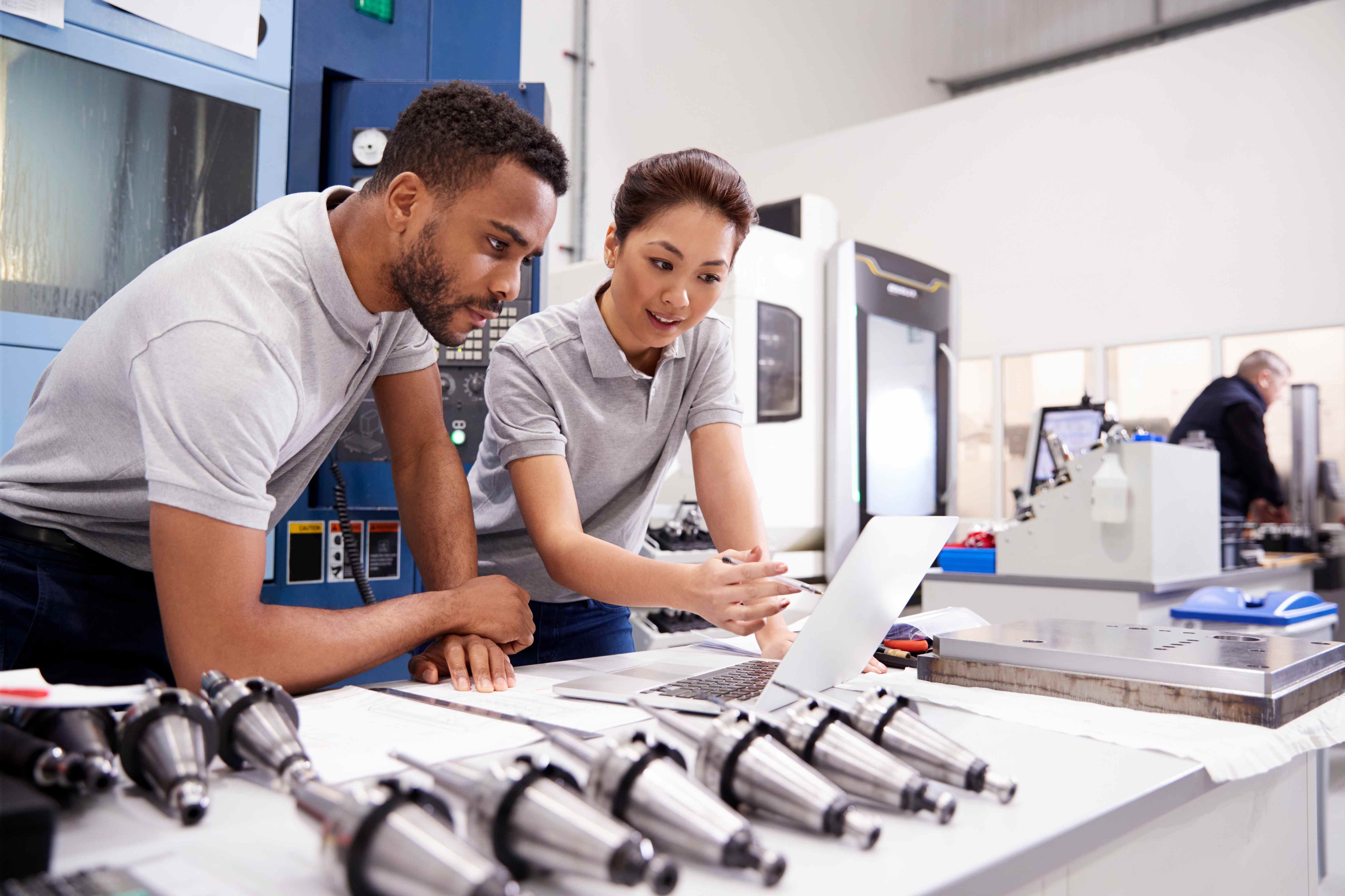 young professionals looking at a laptop in a lab