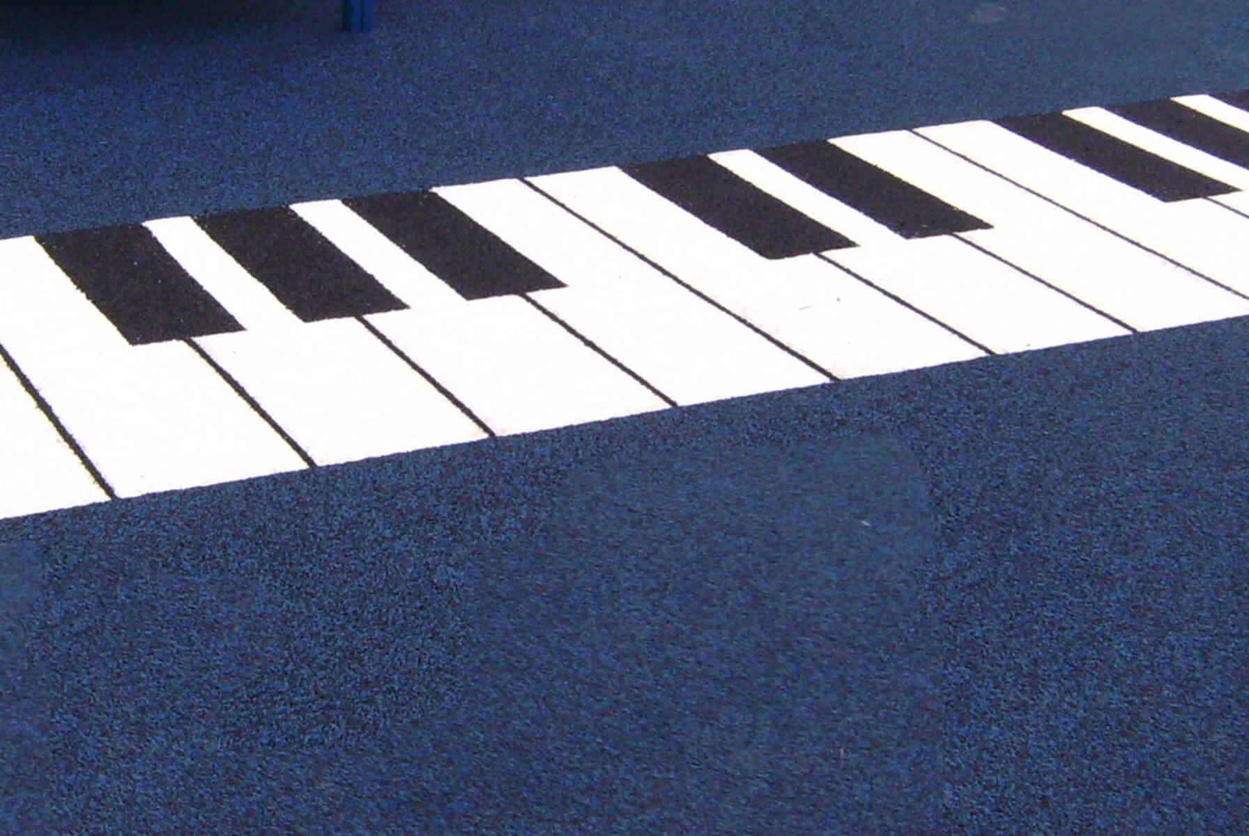 Playground floor painted like piano keys.