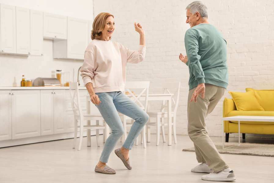 Older couple dancing in kitchen